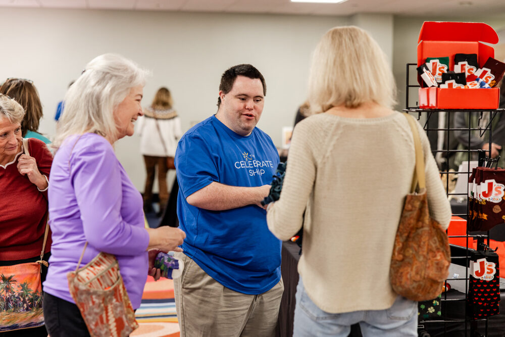 Entrepreneur John speaking with customers at The Celebrate Shop